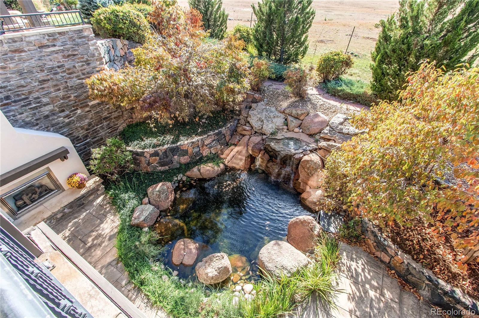 5764 Amber Ridge Drive Castle Pines, CO 80108 - Photo 23 of 50 a aerial view of a house with yard swimming pool and outdoor seating