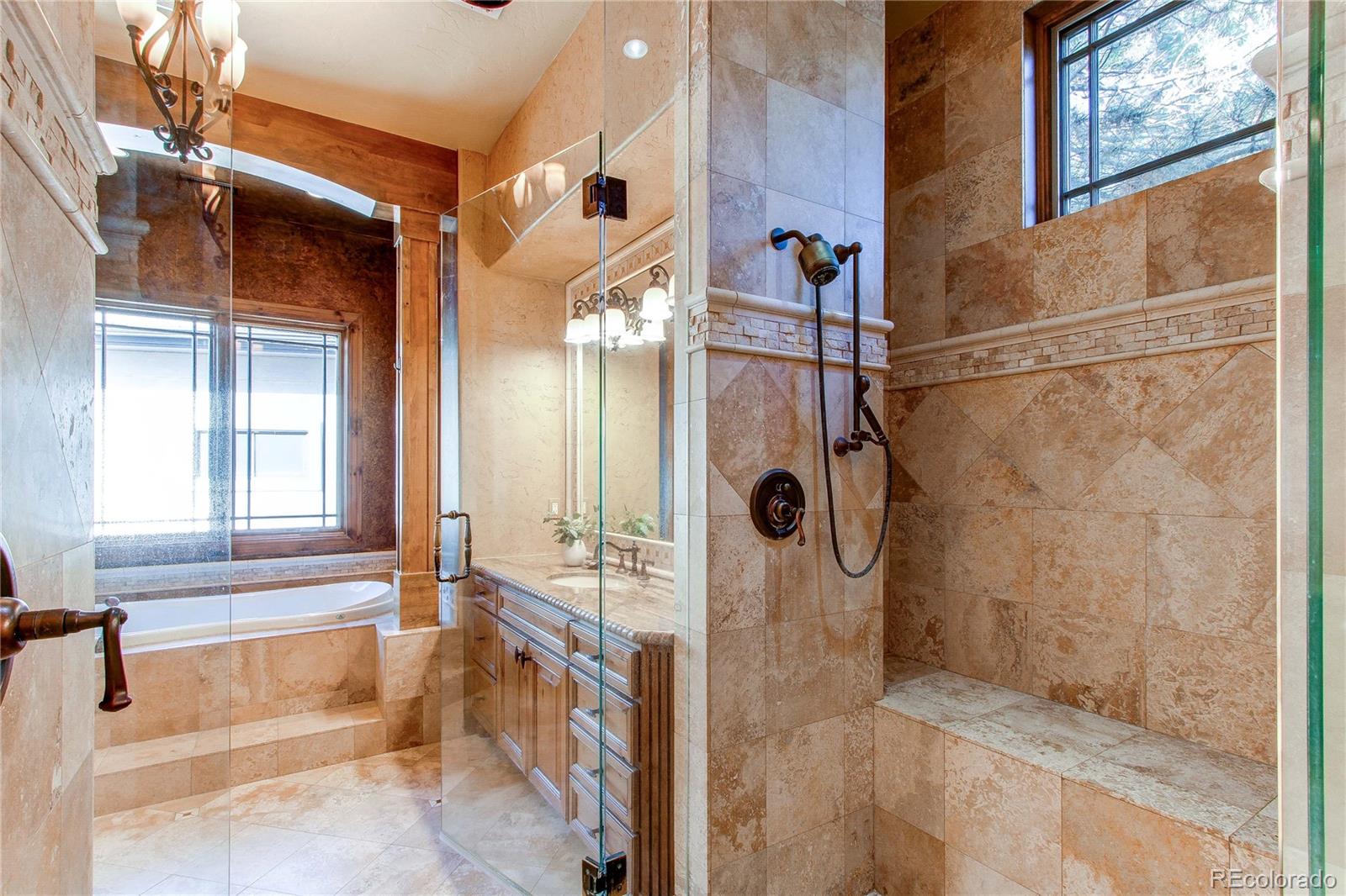 5764 Amber Ridge Drive Castle Pines, CO 80108 - Photo 25 of 50 a bathroom with a tub and shower