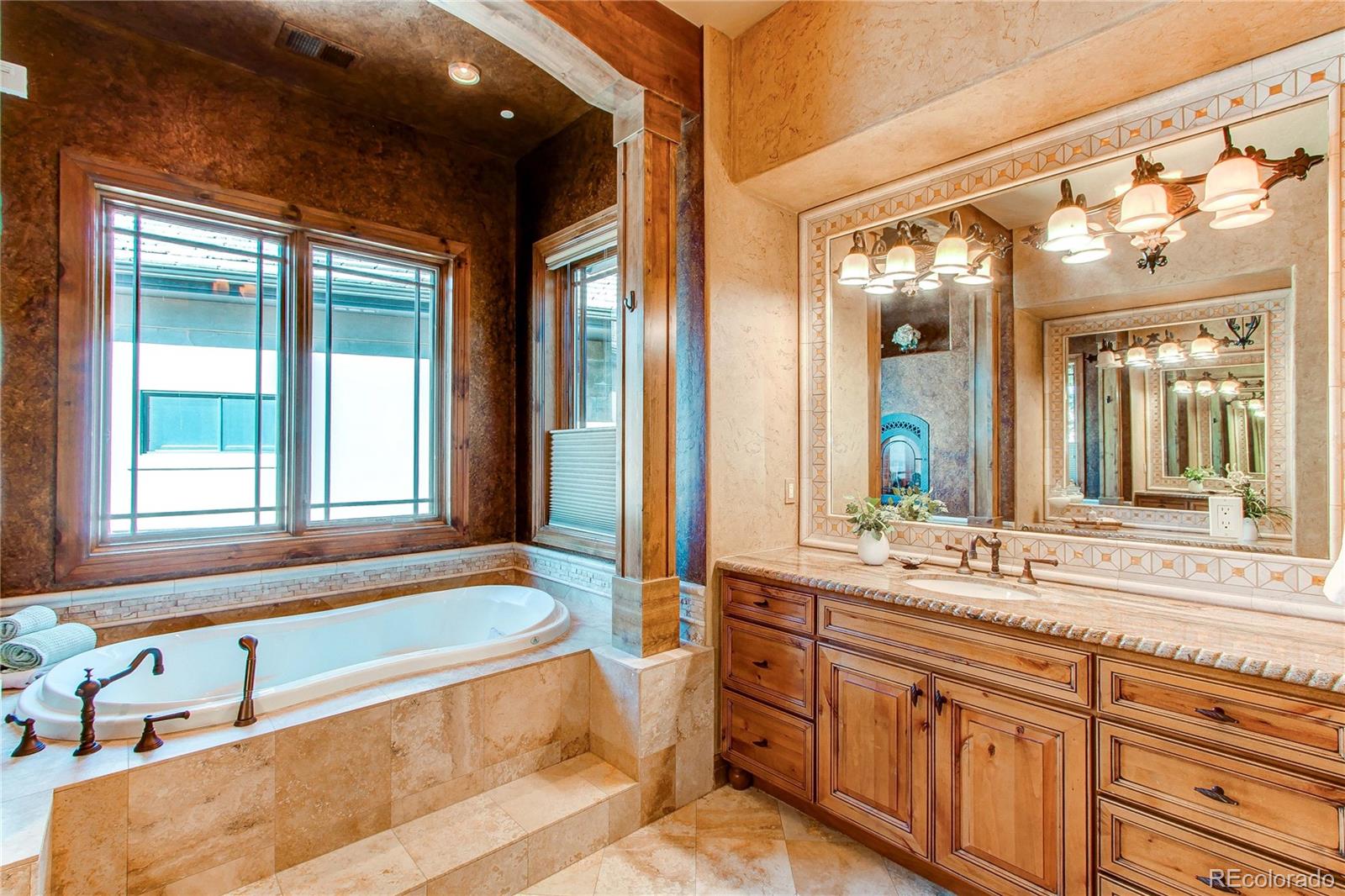 5764 Amber Ridge Drive Castle Pines, CO 80108 - Photo 26 of 50 a bathroom with a tub sink and mirror