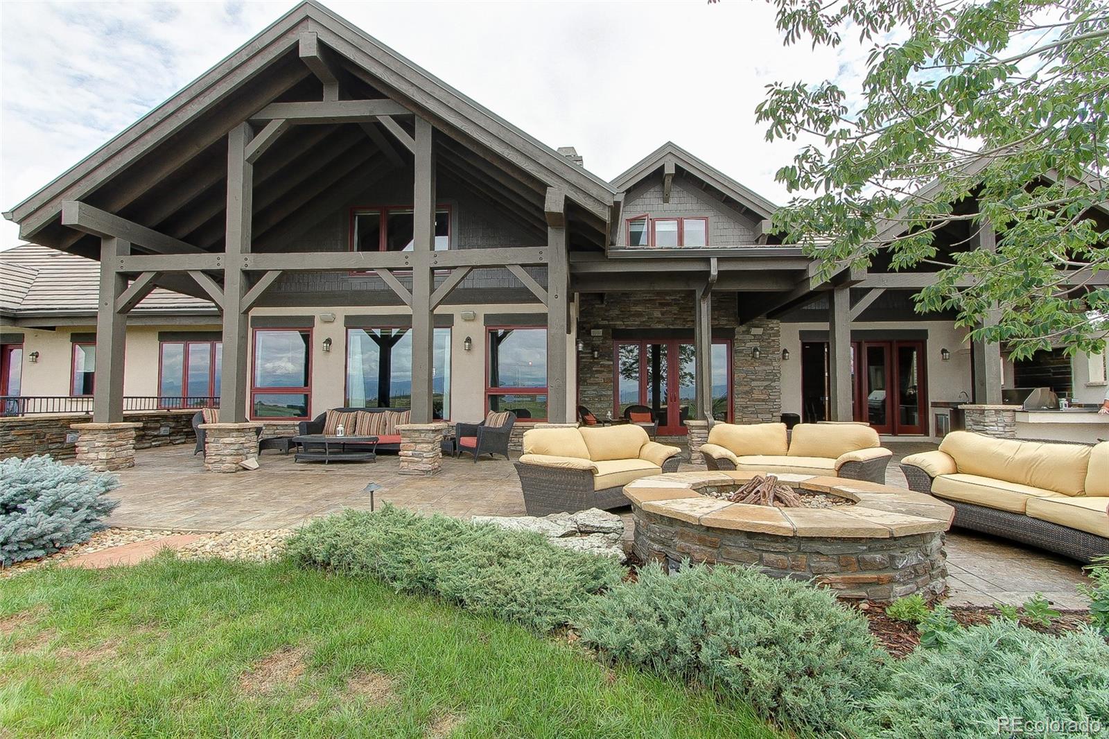 5764 Amber Ridge Drive Castle Pines, CO 80108 - Photo 45 of 50 a view of a house with backyard porch and sitting area