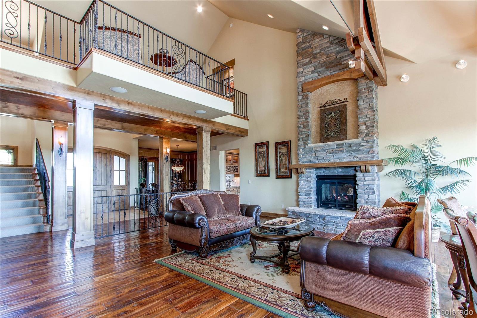 5764 Amber Ridge Drive Castle Pines, CO 80108 - Photo 9 of 50 a living room with furniture or couch and a fireplace