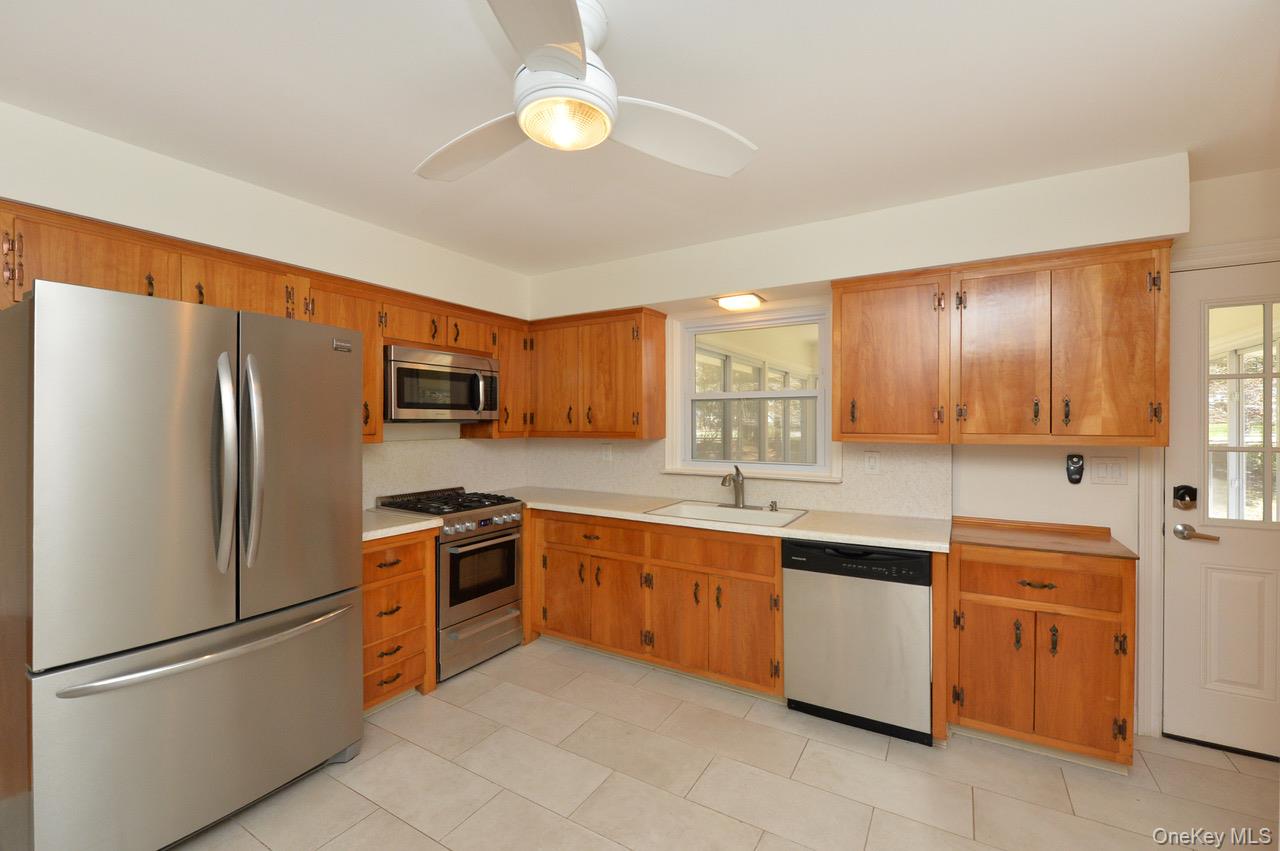 2 Augur Road Airmont, NY 10901 - Photo 13 of 34 a kitchen with stainless steel appliances granite countertop a refrigerator sink and cabinets