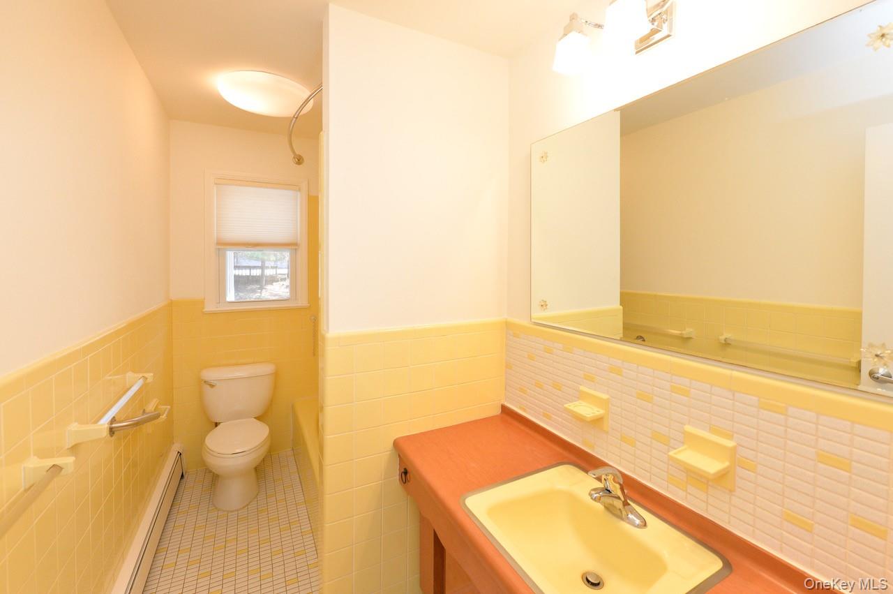 2 Augur Road Airmont, NY 10901 - Photo 21 of 34 a bathroom with a granite countertop sink and a mirror
