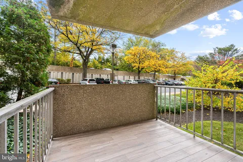 a view of a balcony with wooden floor and fence