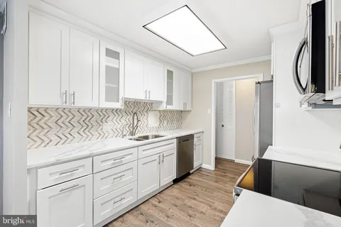 a kitchen with a sink and a refrigerator