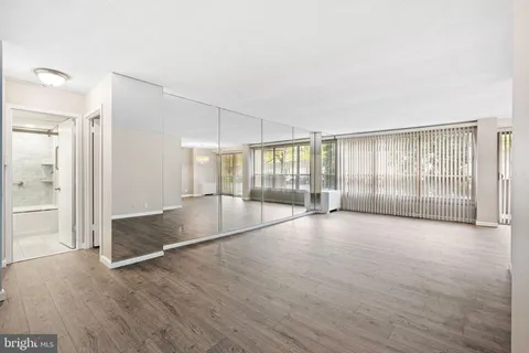 a view of an empty room with glass door