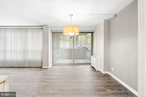 a view of a room with wooden floor and windows