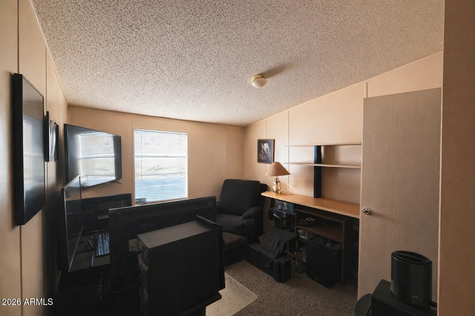 3700 South Tomahawk Road, Unit 99 Apache Junction, AZ 85119 - Photo 8 of 10 a view of a workspace with furniture and a window