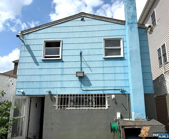 a view of a room with wooden floor and a window