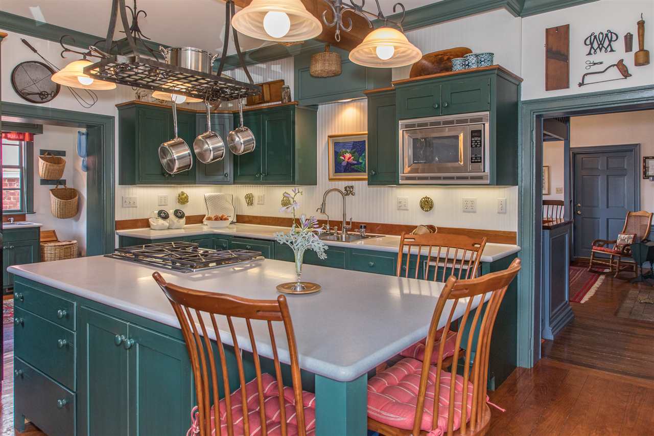 3938 Spring Hill Road Staunton, VA 24401 - Photo 16 of 50 a dining room with furniture a kitchen island and chandelier