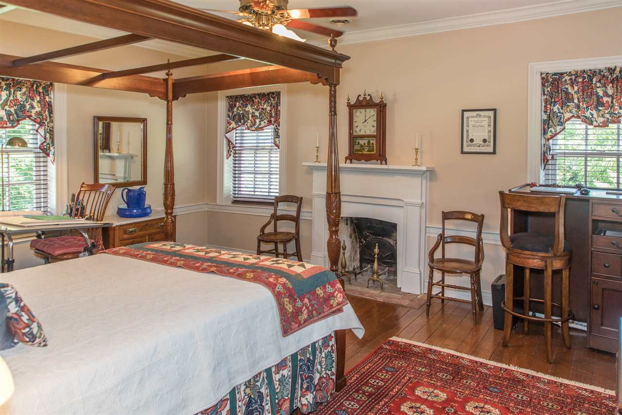 3938 Spring Hill Road Staunton, VA 24401 - Photo 28 of 50 a bed room with furniture and a fireplace