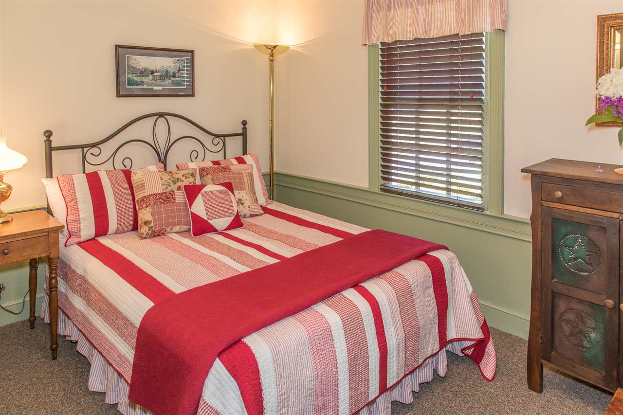 3938 Spring Hill Road Staunton, VA 24401 - Photo 43 of 50 a bedroom with a bed a dresser next to a window