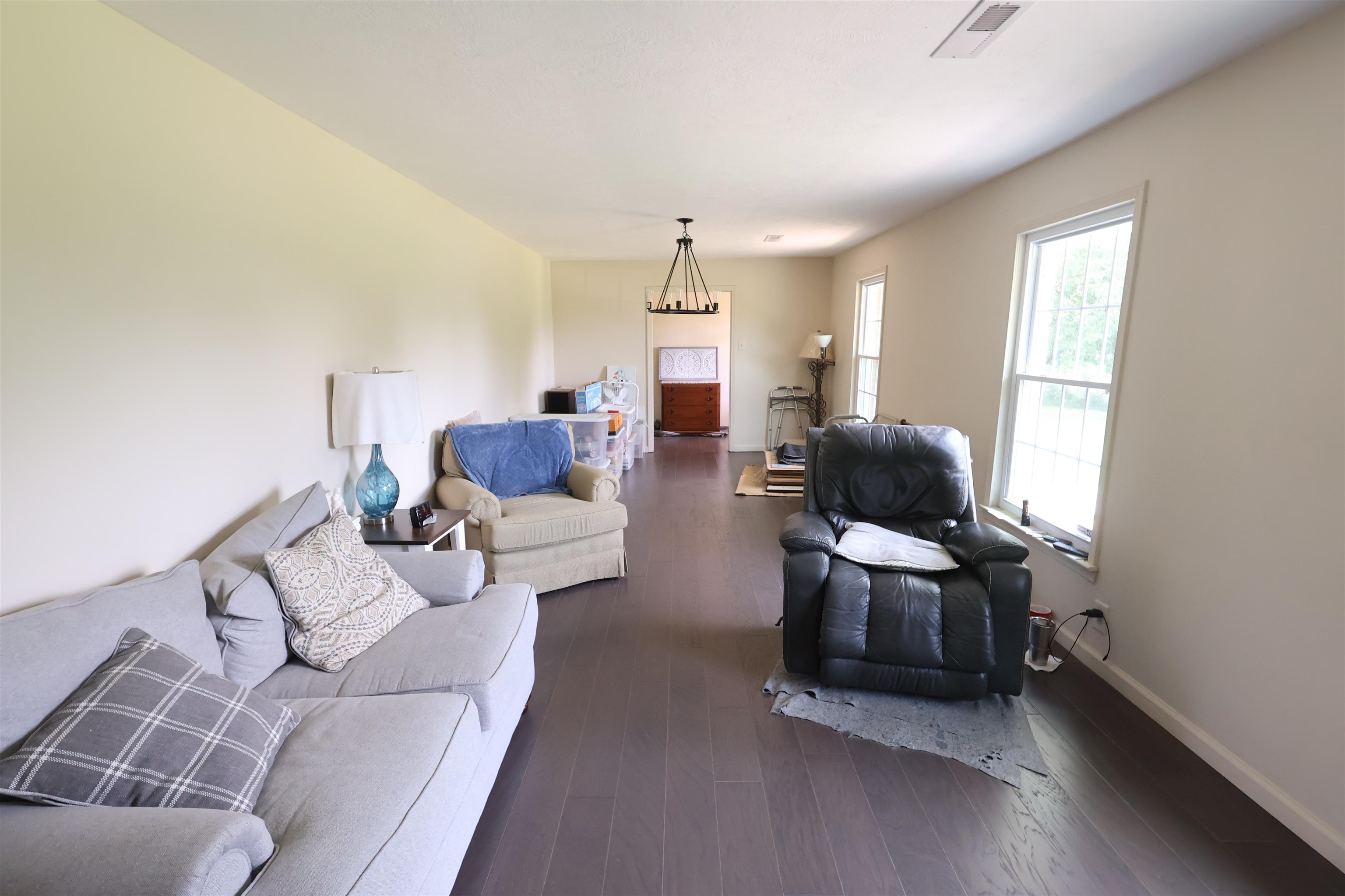 3226 19th Highway West Ripley, TN 38063 - Photo 4 of 18 Spacious interior featuring wood-finish flooring, two large windows, and a ceiling-mounted light fixture