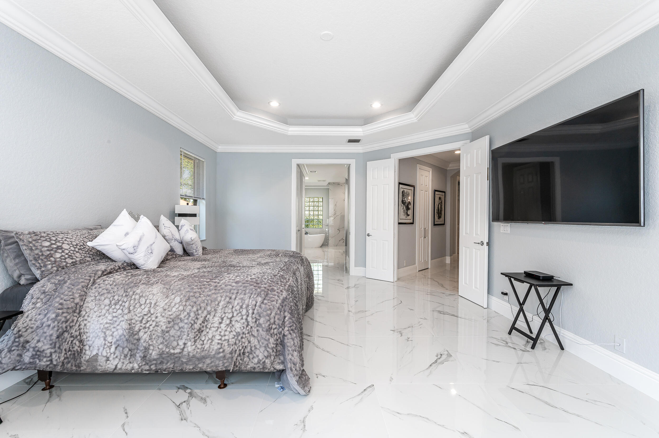 21254 Falls Ridge Way Boca Raton, FL 33428 - Photo 13 of 25 a spacious bedroom with a bed and a flat screen tv