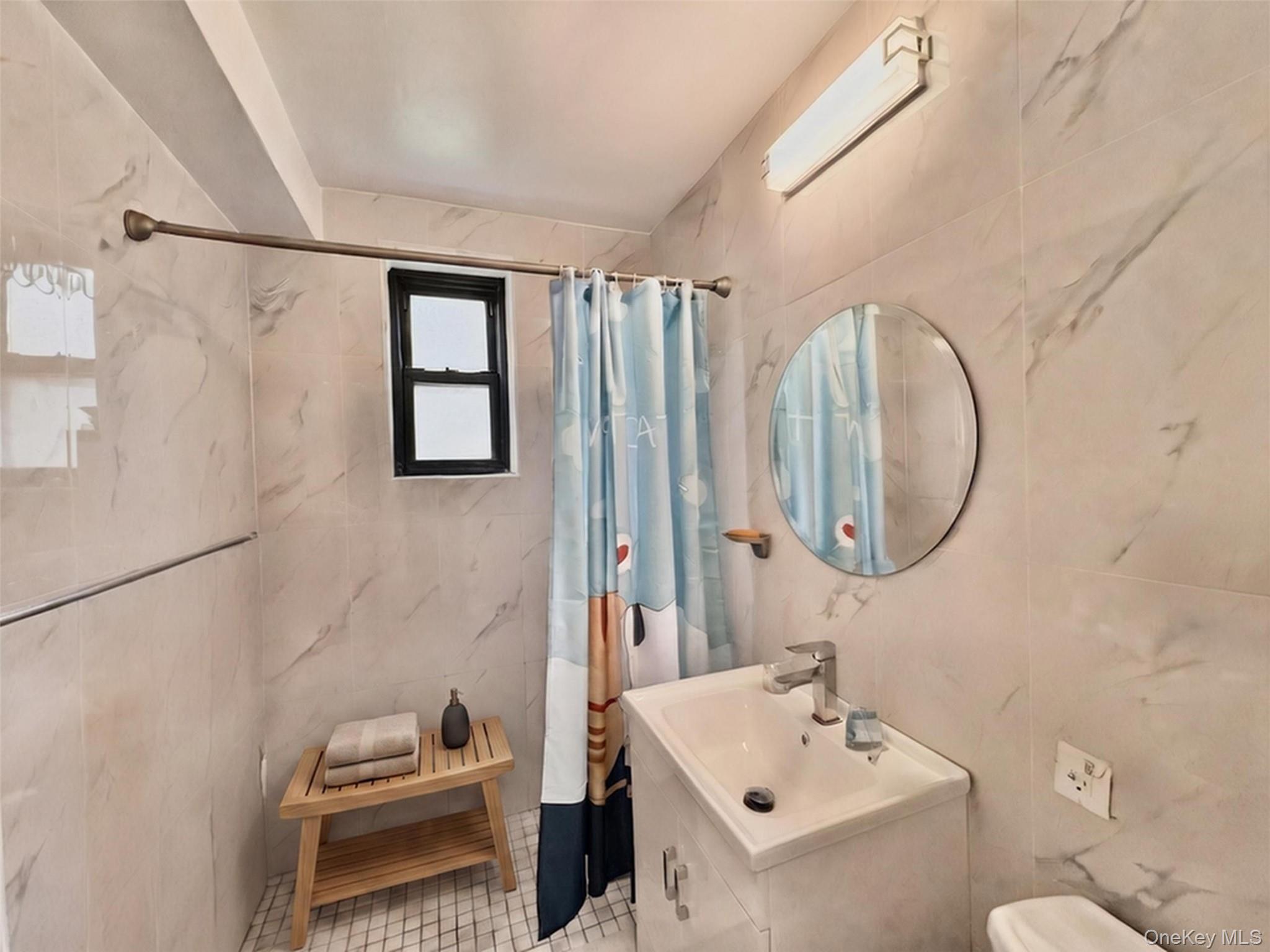 138-12 28th Road, Unit 1F Queens, NY 11354 - Photo 5 of 8 a bathroom with a sink toilet and shower