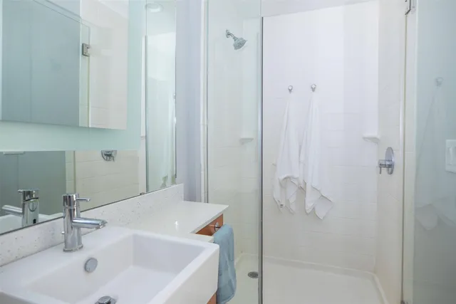 a bathroom with a sink and shower