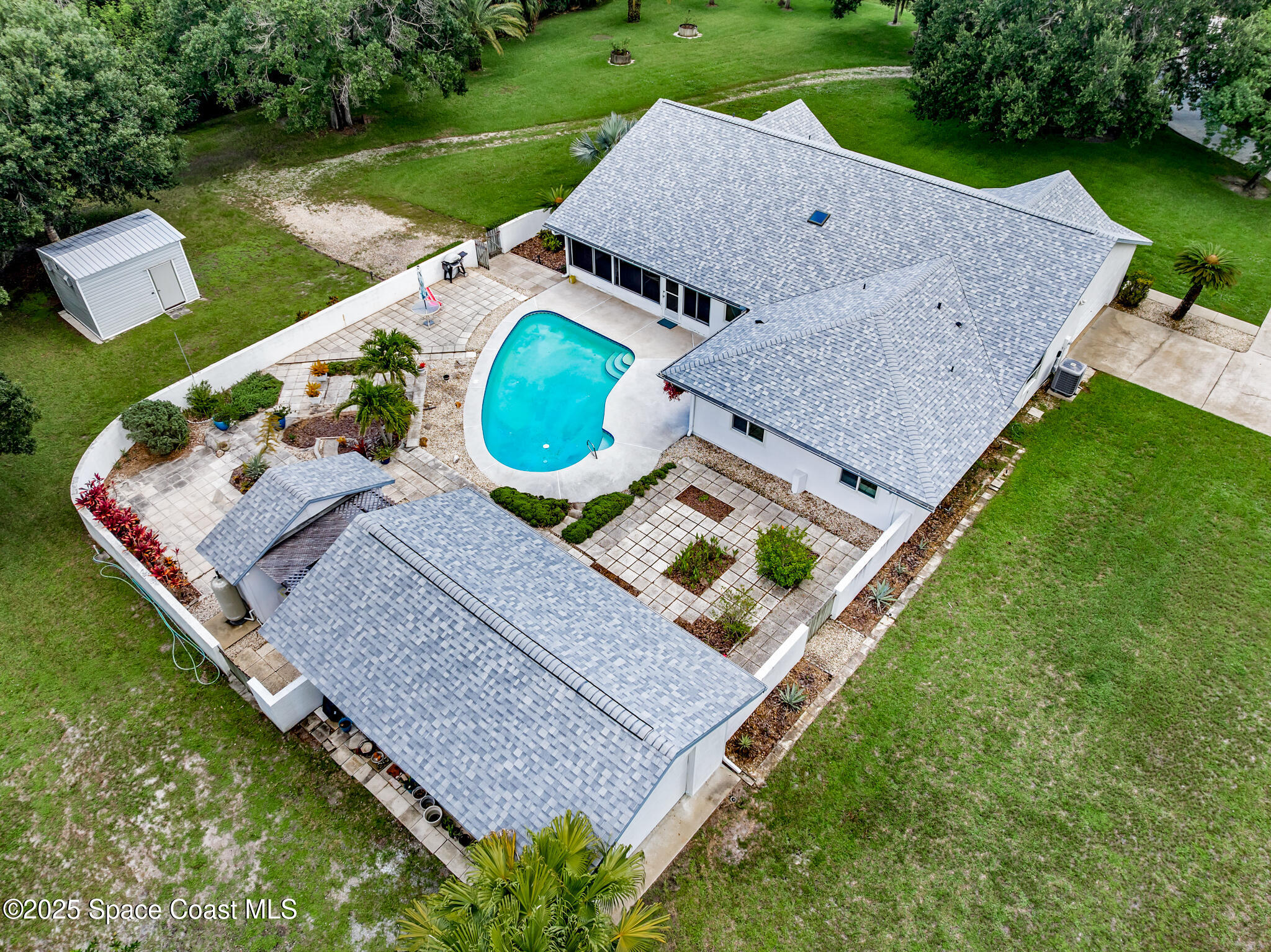 3340 Weber Road Malabar, FL 32950 - Photo 2 of 96 an aerial view of a house with a garden and swimming pool