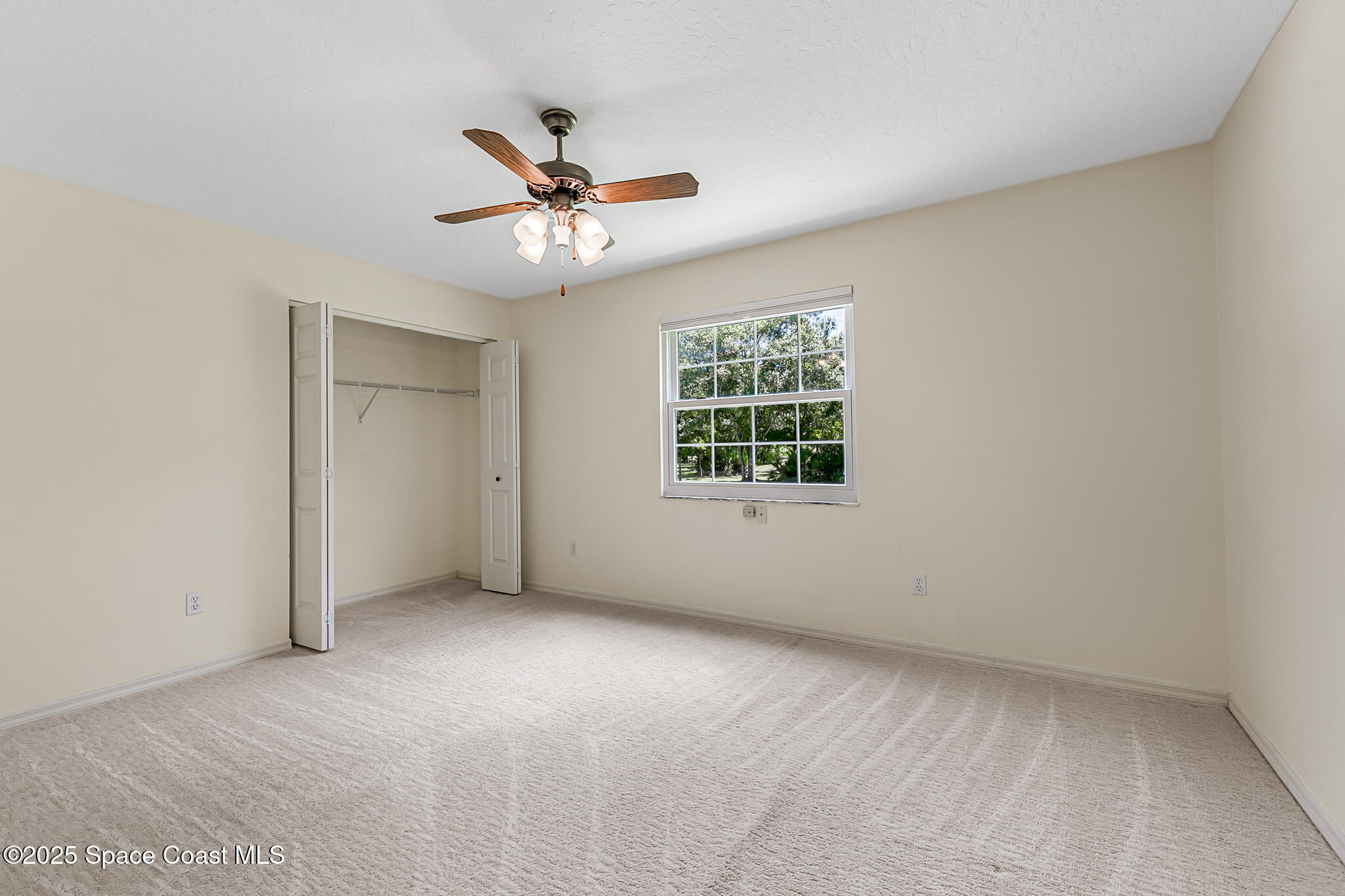 3340 Weber Road Malabar, FL 32950 - Photo 36 of 96 an empty room with a window and a fan