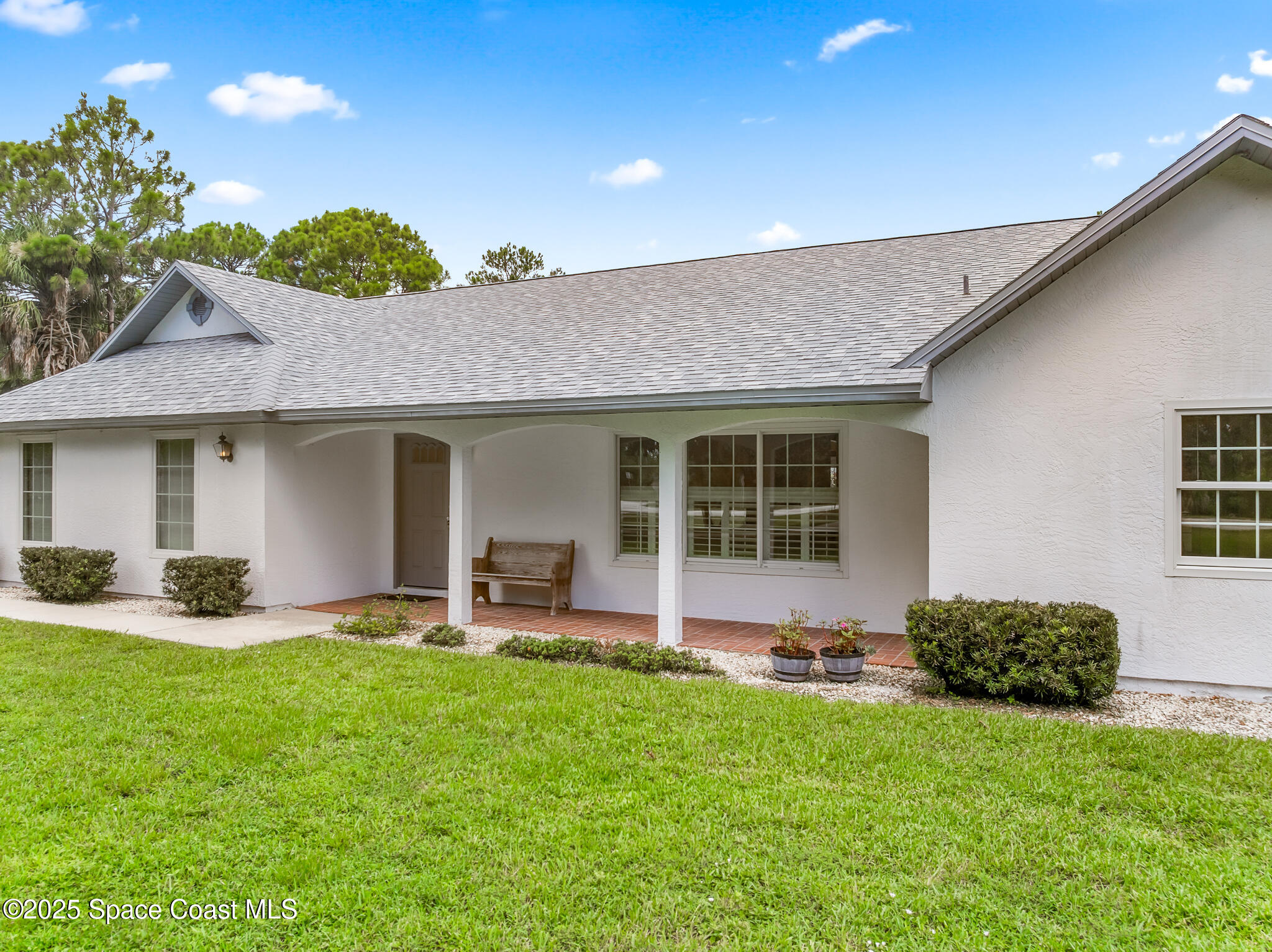 3340 Weber Road Malabar, FL 32950 - Photo 5 of 96 a front view of a house with a yard and outdoor seating