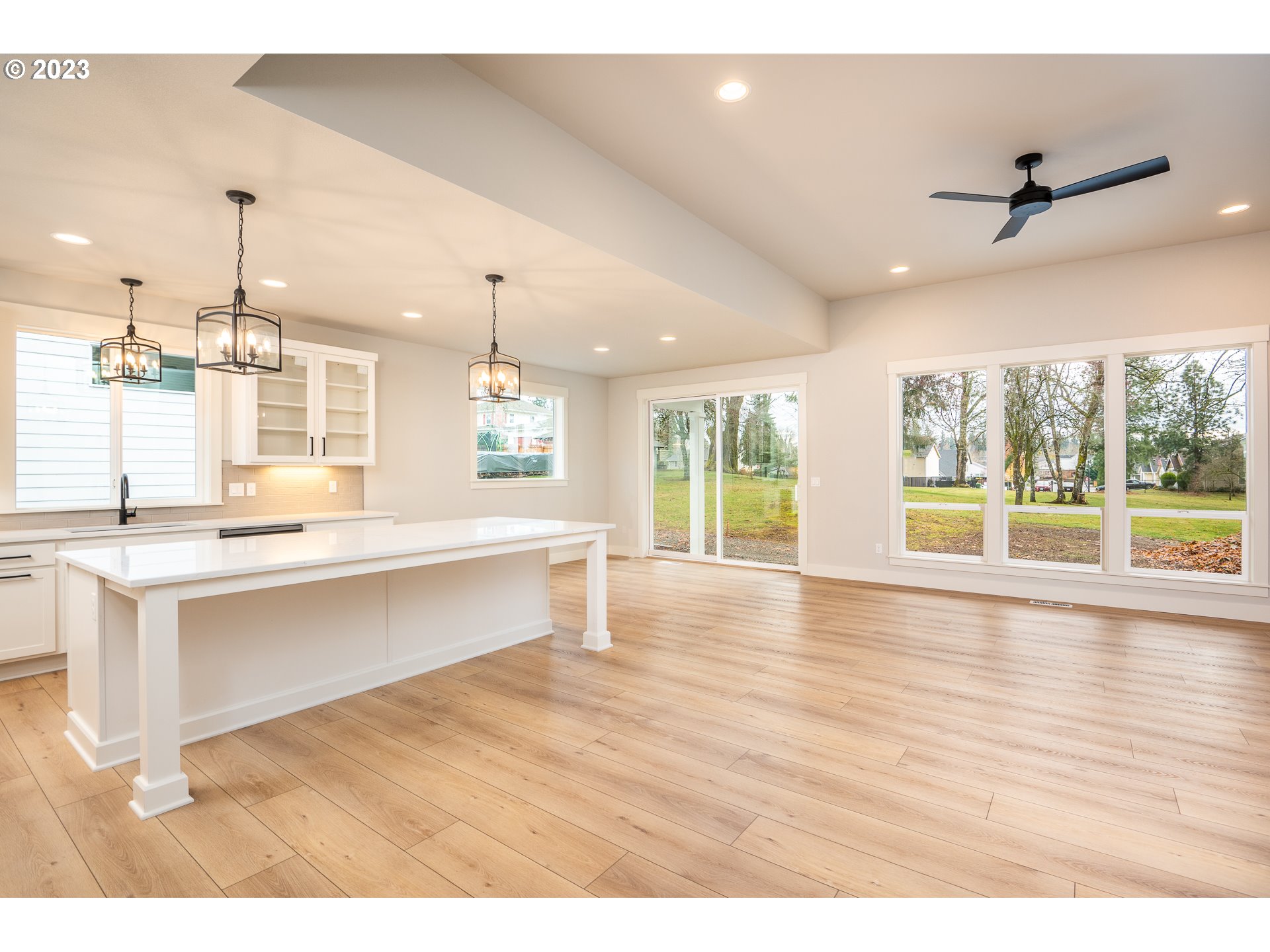 37772 Southeast Olson Street Sandy, OR 97055 - Photo 14 of 32 a open kitchen with granite countertop a stove top oven a sink with wooden floors and cabinets