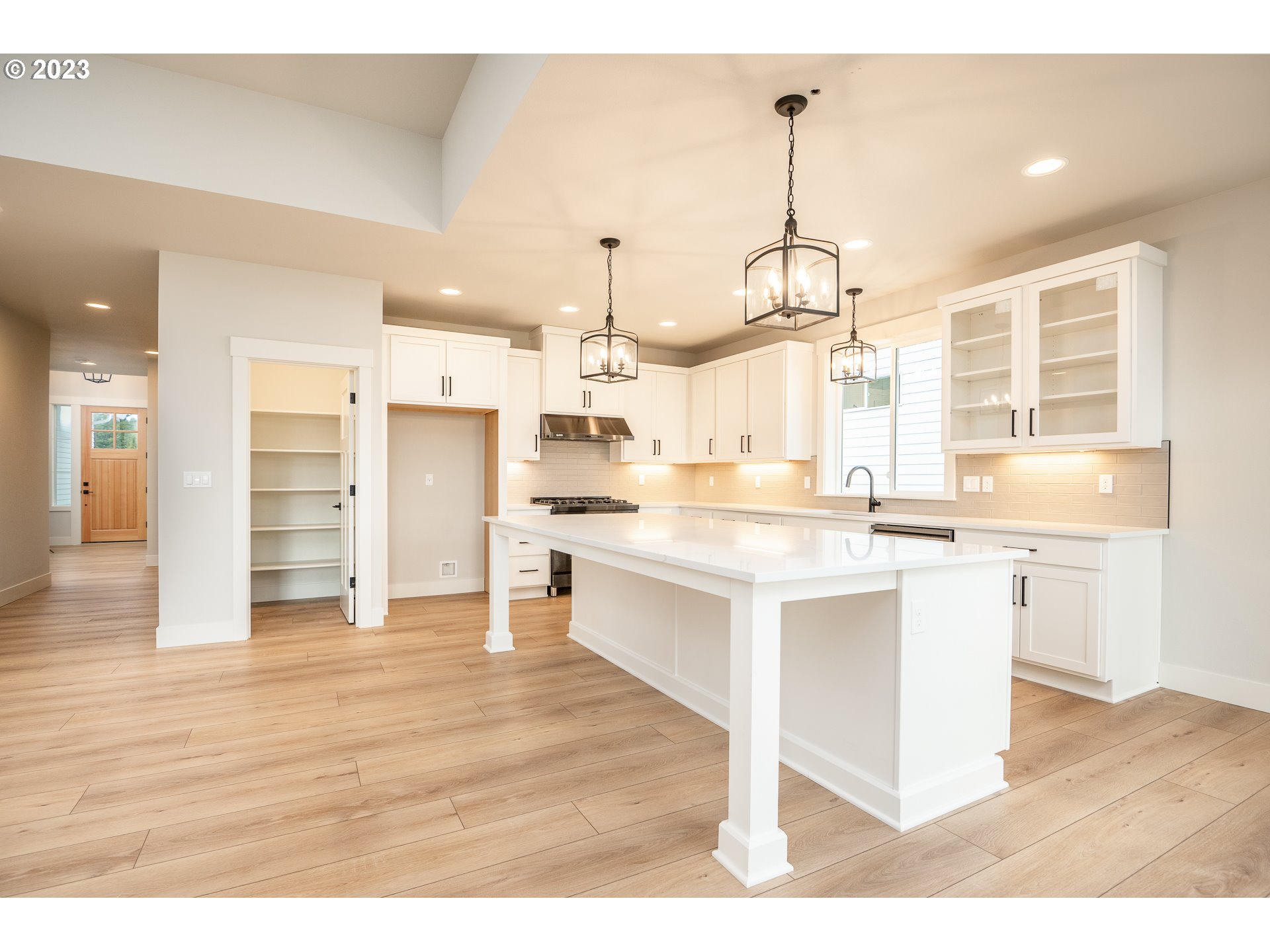 37772 Southeast Olson Street Sandy, OR 97055 - Photo 17 of 32 a kitchen with stainless steel appliances kitchen island granite countertop a stove a sink and a wooden floors