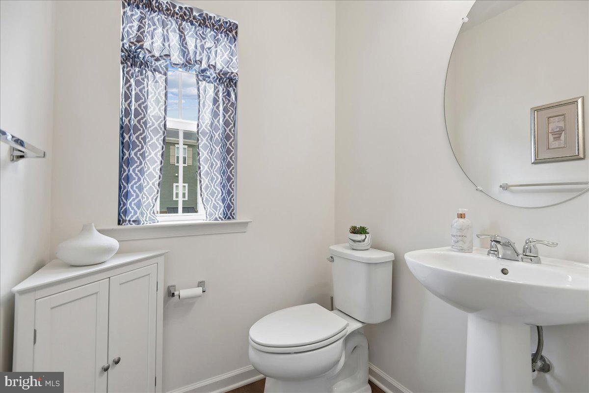1813 Iris Lane Hanover, MD 21076 - Photo 13 of 20 a bathroom with a toilet a sink and a mirror
