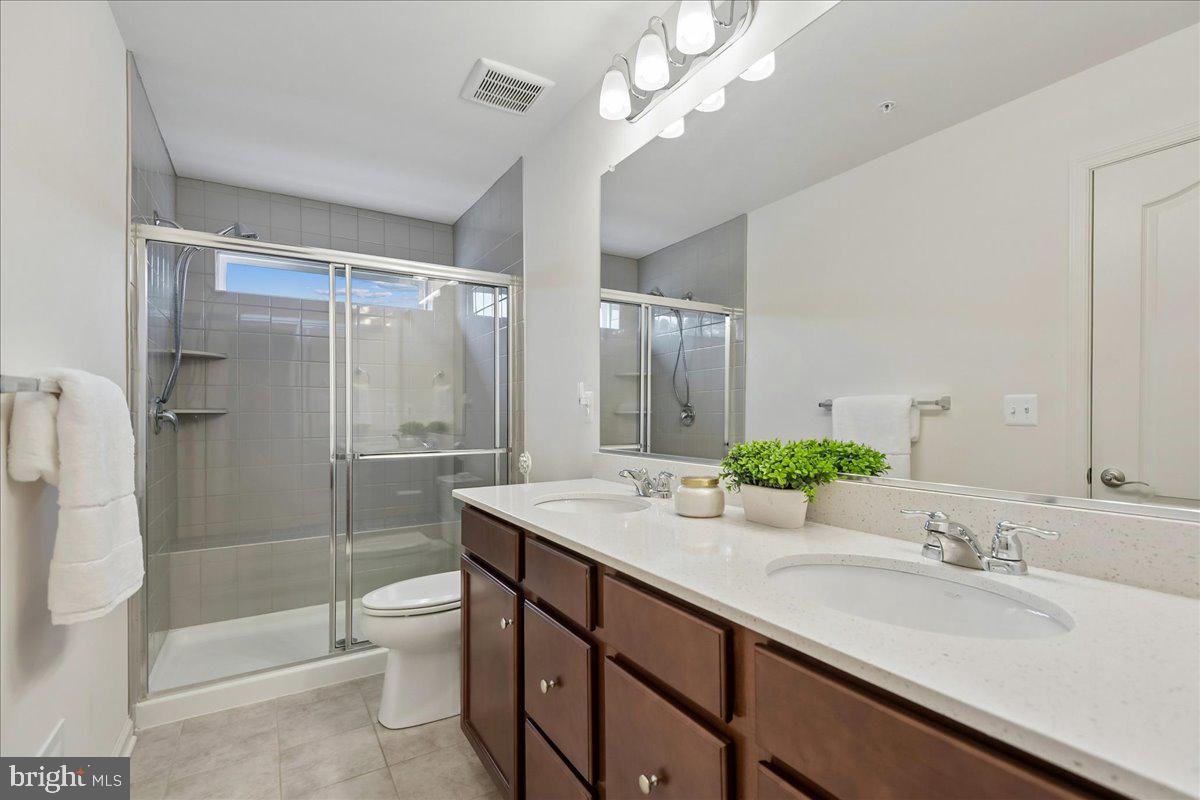 1813 Iris Lane Hanover, MD 21076 - Photo 16 of 20 a bathroom with a sink a toilet a mirror and shower