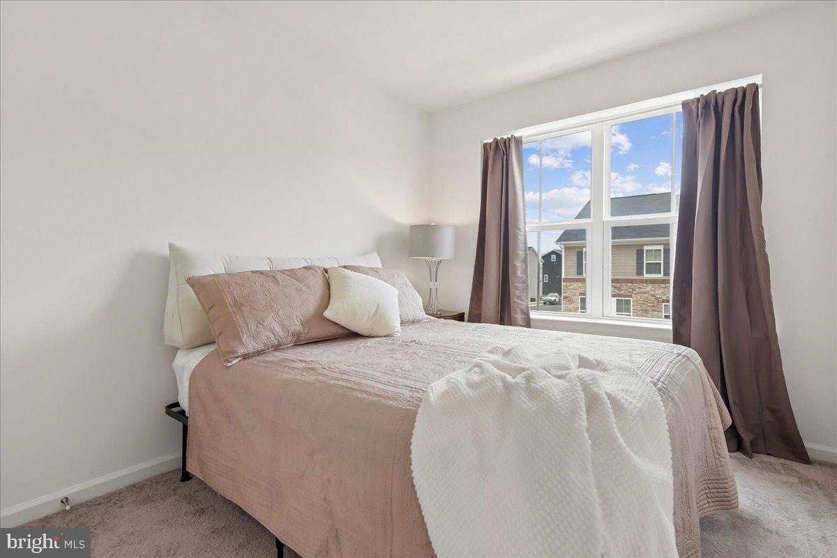 1813 Iris Lane Hanover, MD 21076 - Photo 17 of 20 a large bed sitting in a bedroom next to a window