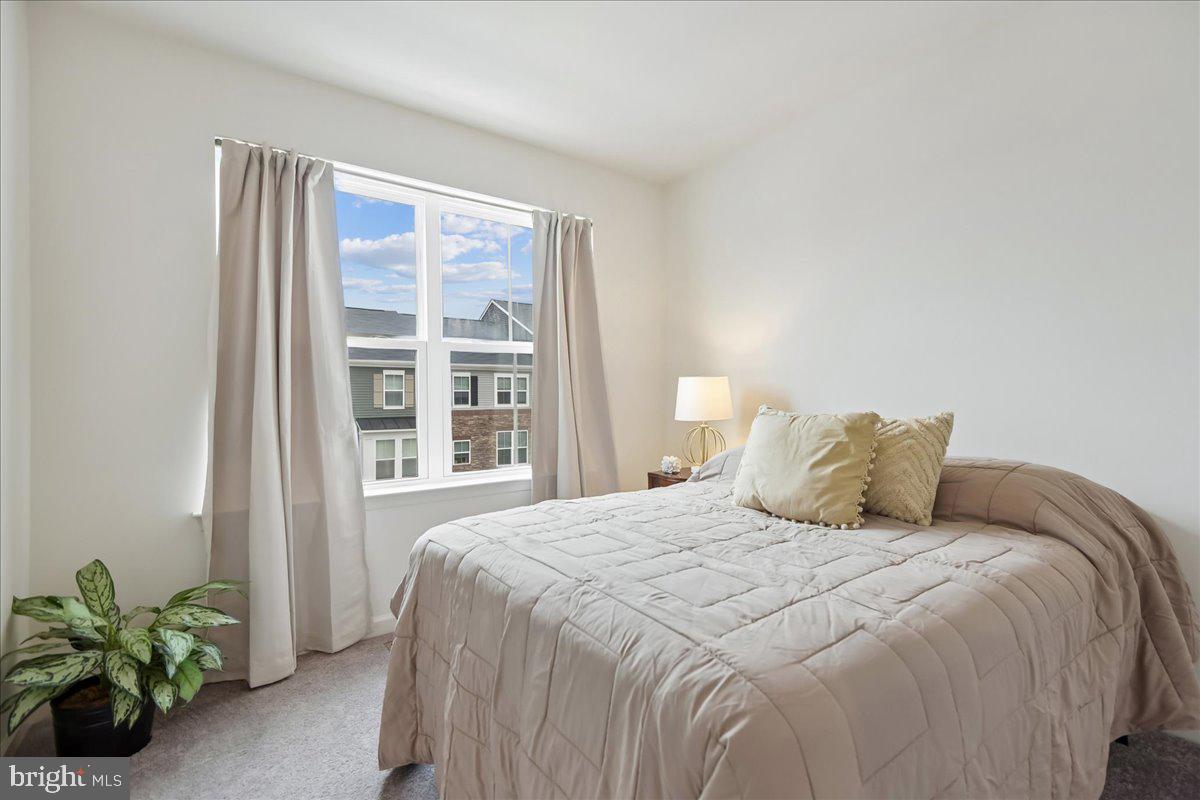 1813 Iris Lane Hanover, MD 21076 - Photo 19 of 20 a large bed sitting in a bedroom next to a window