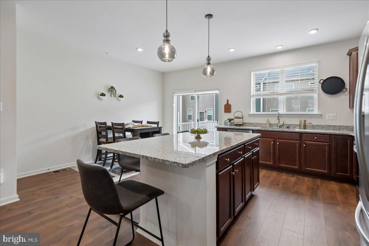 1813 Iris Lane Hanover, MD 21076 - Photo 7 of 20 a kitchen with a sink a stove cabinets and wooden floor