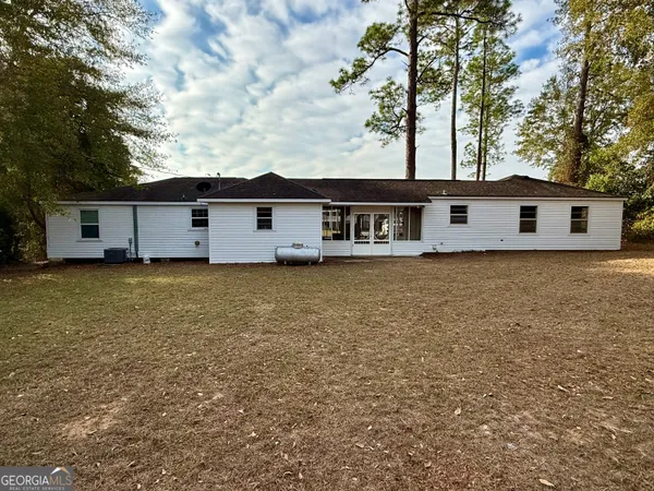 a view of house with backyard