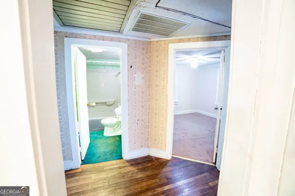 a view of a bathroom from a hallway