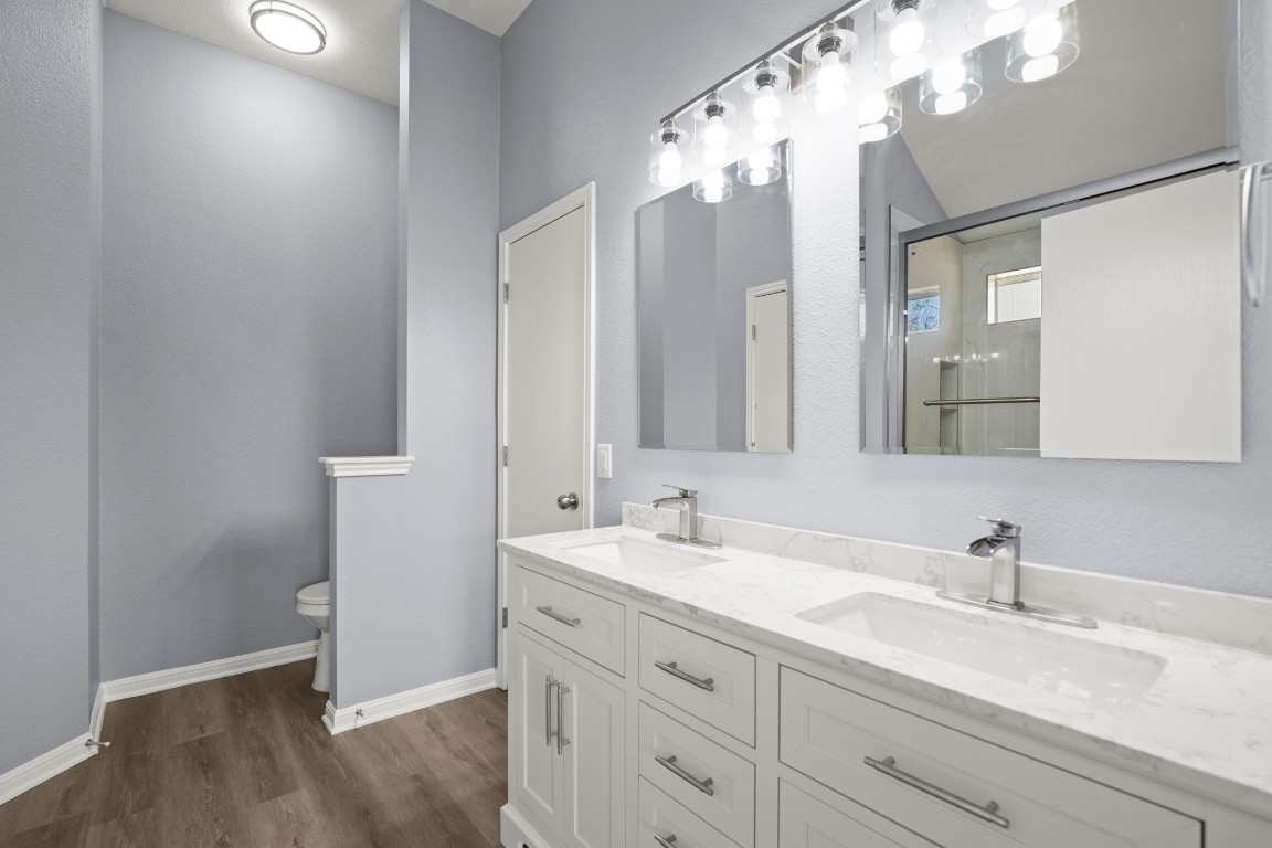 14303 Cummins Way Manor, TX 78653 - Photo 14 of 25 a bathroom with a double vanity sink mirror and double
