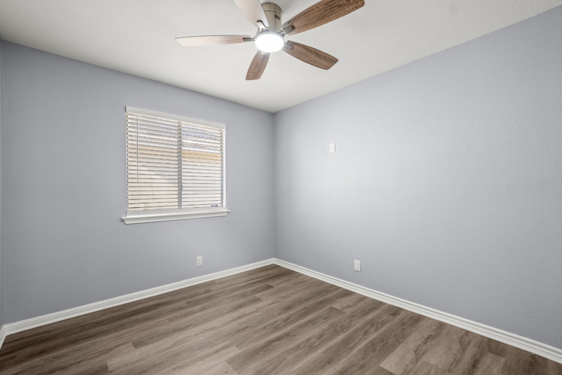 14303 Cummins Way Manor, TX 78653 - Photo 17 of 25 an empty room with a window and a fan