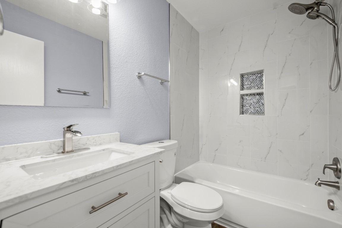 14303 Cummins Way Manor, TX 78653 - Photo 18 of 25 a bathroom with a sink toilet a bathtub and vanity