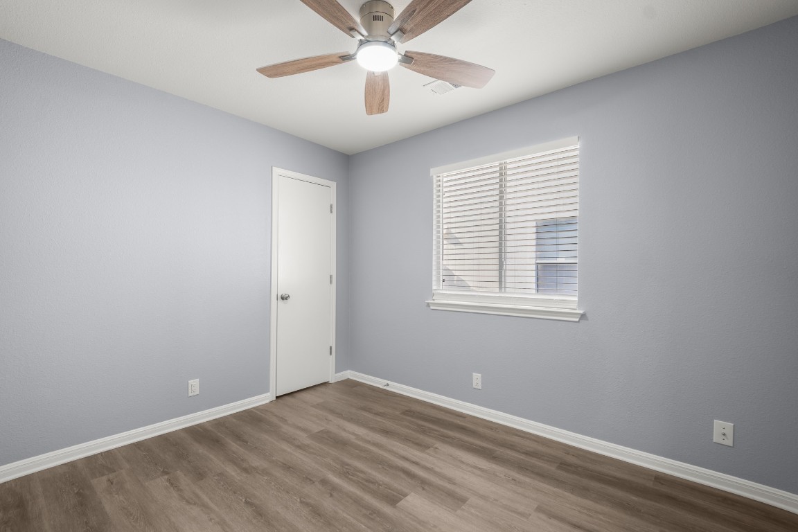 14303 Cummins Way Manor, TX 78653 - Photo 19 of 25 an empty room with a window and a fan
