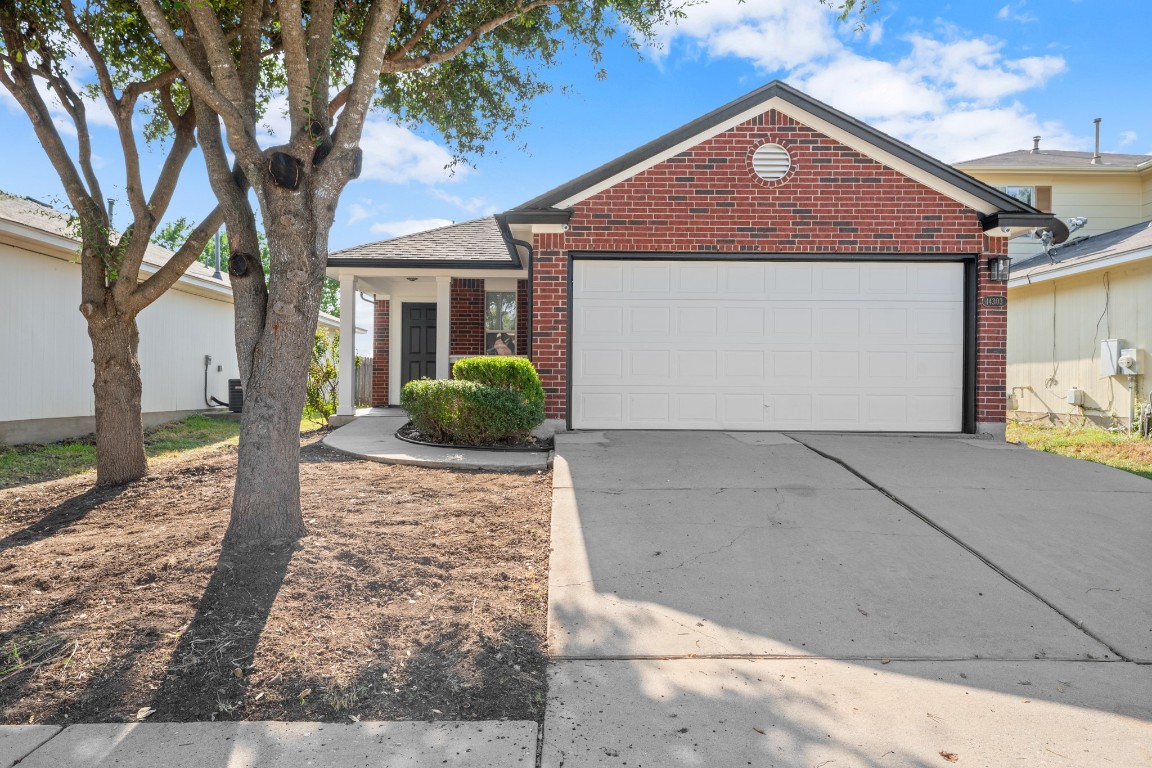 14303 Cummins Way Manor, TX 78653 - Photo 2 of 25 a front view of a house with garden