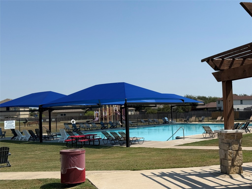 14303 Cummins Way Manor, TX 78653 - Photo 24 of 25 a view of a swimming pool with a patio