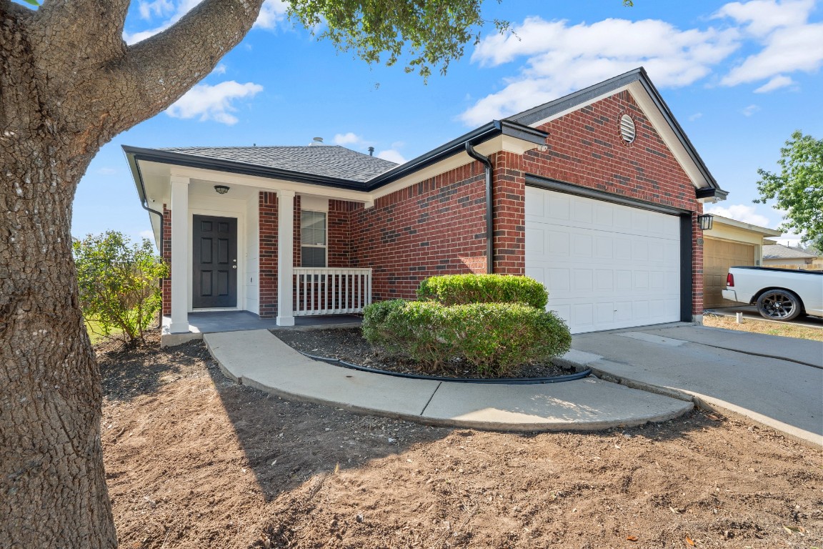 14303 Cummins Way Manor, TX 78653 - Photo 3 of 25 a view of a house with a small yard and plants