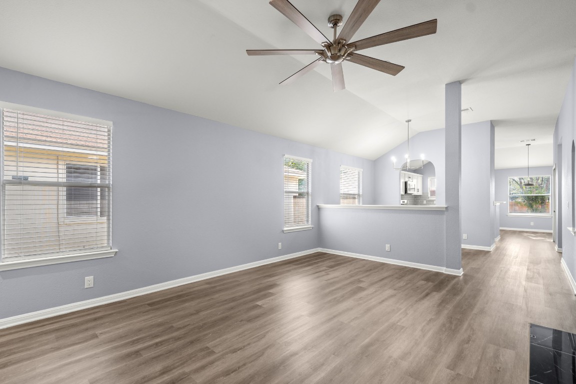 14303 Cummins Way Manor, TX 78653 - Photo 5 of 25 a view of a kitchen with wooden floor and a kitchen