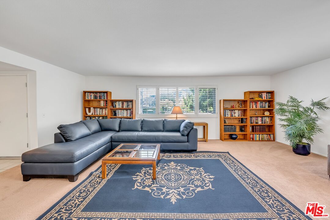 2774 Monticello Road Claremont, CA 91711 - Photo 7 of 34 a living room with furniture and a book shelf