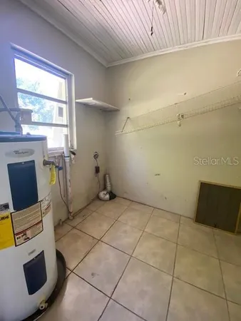 a view of a storage & utility room with a window