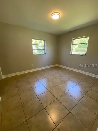 a view of an empty room and a window