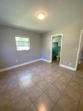 an empty room with a empty space and windows