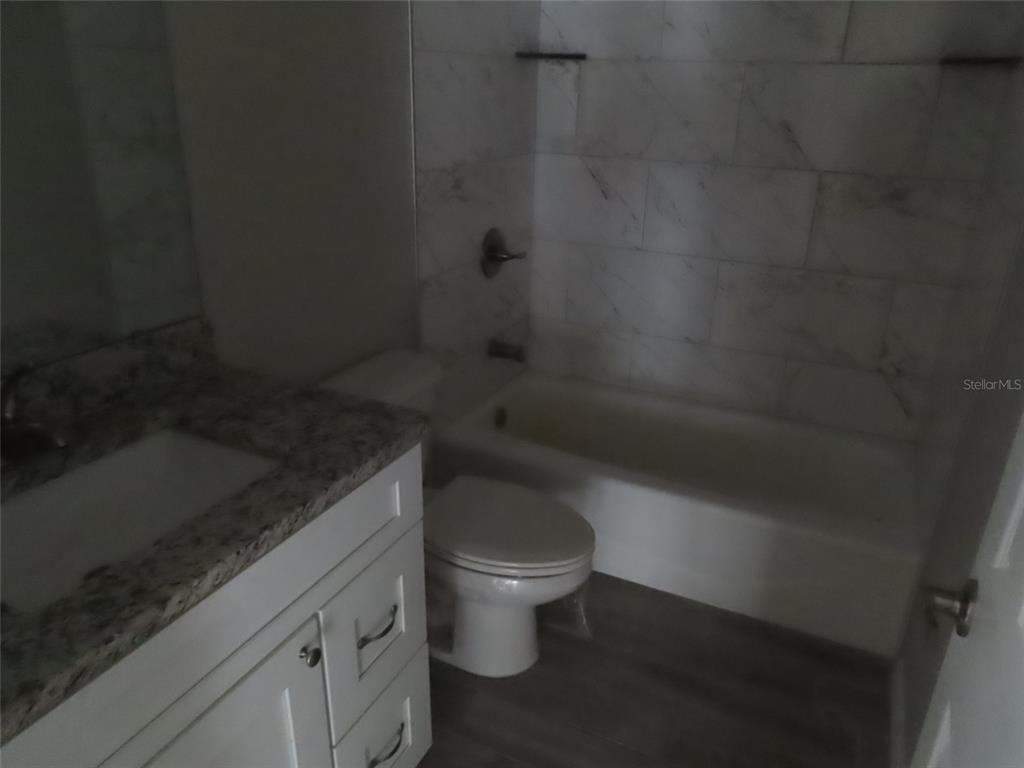 2501 Shirah Road Auburndale, FL 33823 - Photo 11 of 17 a bathroom with a granite countertop toilet and a sink