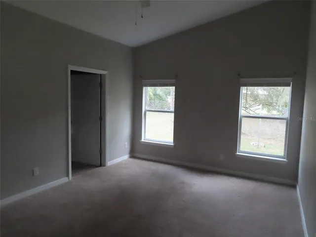 a bathroom with a granite countertop toilet and sink