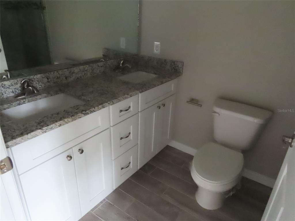 2501 Shirah Road Auburndale, FL 33823 - Photo 14 of 17 a bathroom with a granite countertop toilet and sink