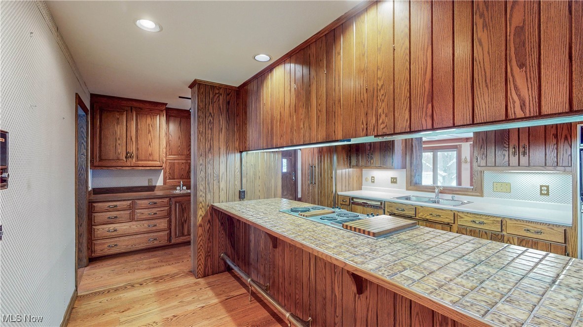 1091 Sand Run Road Akron, OH 44313 - Photo 10 of 26 There's a long ceramic tiled breakfast bar with brass footrail leading to a butler's pantry.