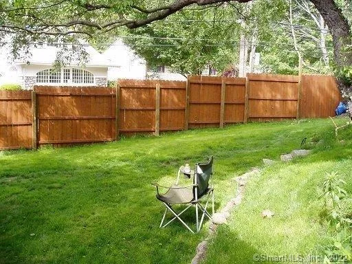 a view of a backyard with chairs