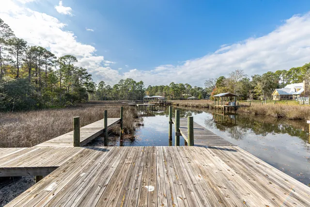 a view of a lake with tables and chairs